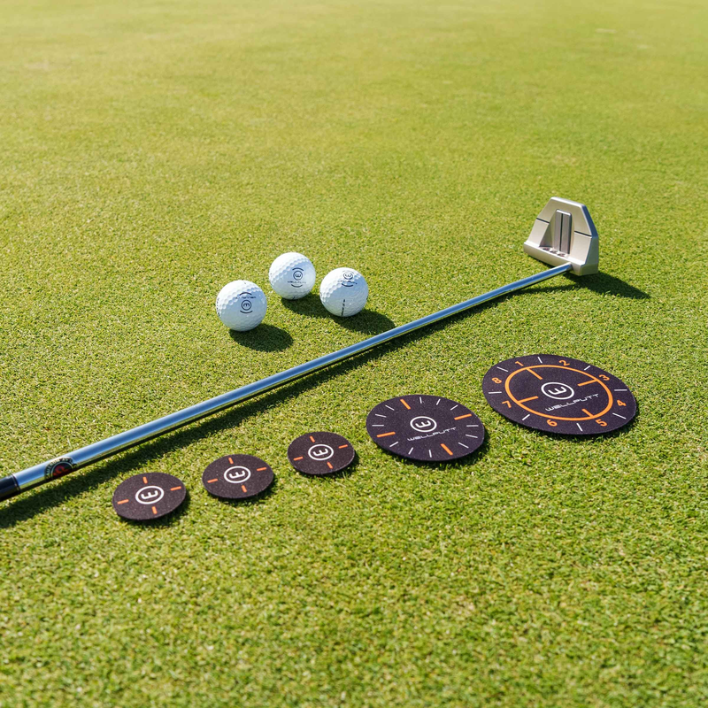 Ghost Hole 3 Sizes targets on a putting green with a putter.