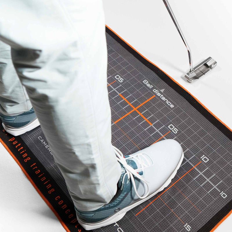 Golfer using the Welltowel as a stance guide.