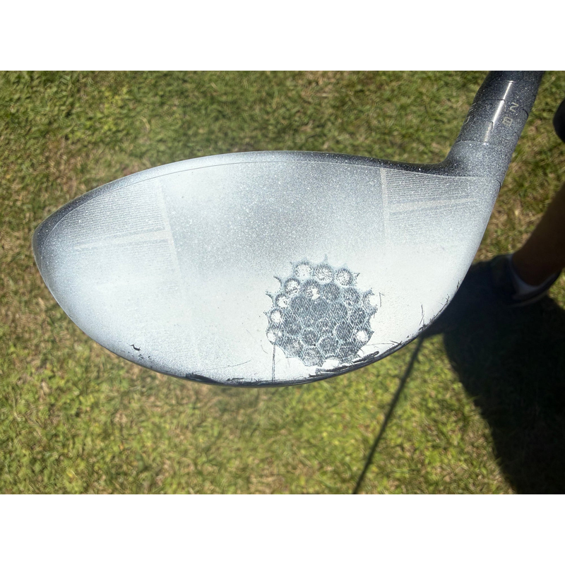 Driver clubface coated with InkPact Micron showing a clear ball strike mark.