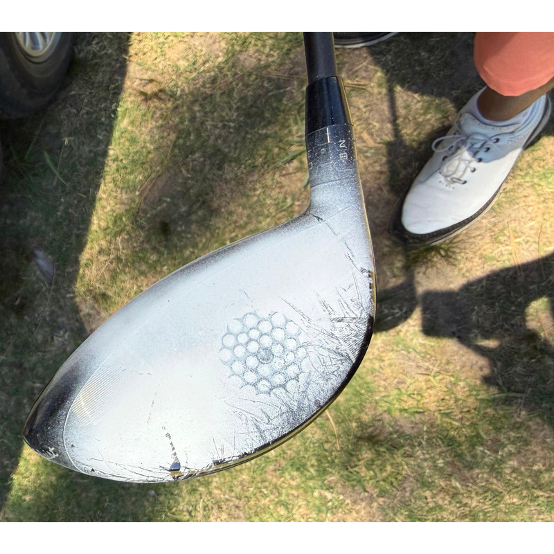 Driver clubface coated with InkPact Micron showing a strike mark on the range.