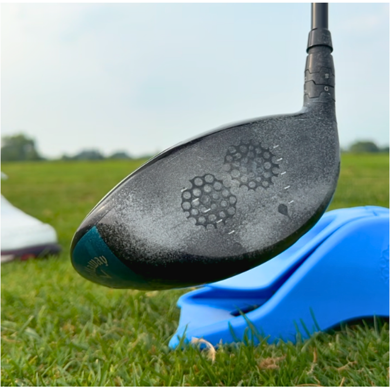 Driver clubface showing two ball strike marks from the InkPact Printer coating.