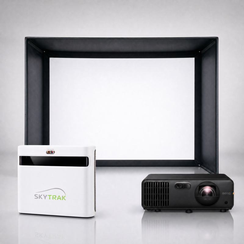 SkyTrak+ launch monitor package hero image showing the SIG DIY Golf Simulator Enclosure with a BenQ short-throw projector on a grey studio background.